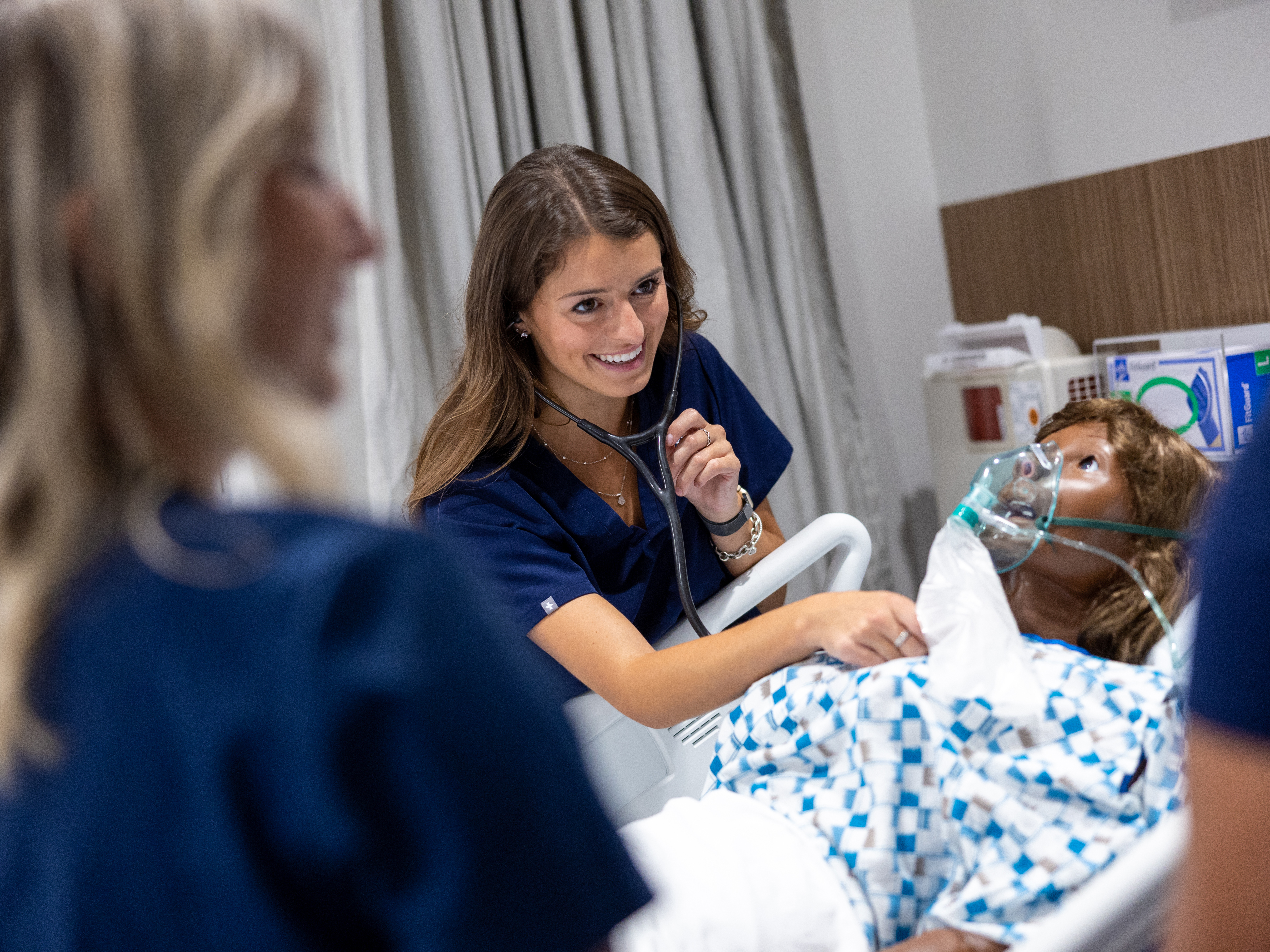 nursing students work with a dummy
