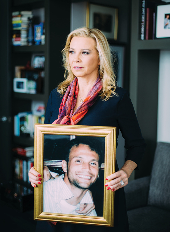 image of cammie rice holding a photo of her son who passed away from opioid addiction