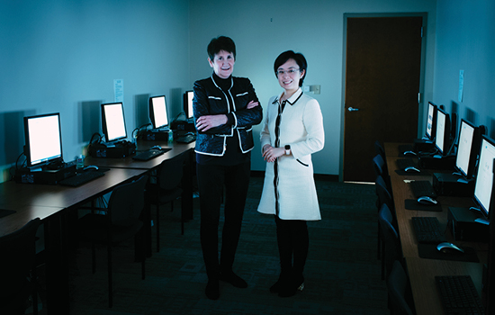 Jeannie Cimiotti and Yin Li standing in a computer lab